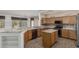 Open kitchen boasts granite countertops, stainless steel appliances and island at 15136 W Cactus Ridge Way, Surprise, AZ 85374