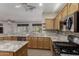 Bright kitchen with granite counters, stainless steel appliances, open layout at 15136 W Cactus Ridge Way, Surprise, AZ 85374