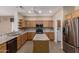 Modern kitchen boasts granite countertops, stainless appliances and island at 15136 W Cactus Ridge Way, Surprise, AZ 85374
