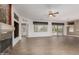 Spacious living room with wood-look tile floors, fireplace, neutral walls, and lots of natural light at 15136 W Cactus Ridge Way, Surprise, AZ 85374
