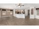 Spacious living room with open access to kitchen, wood-look tile floors, and lots of natural light at 15136 W Cactus Ridge Way, Surprise, AZ 85374