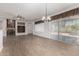 Bright living room with fireplace, tile floors, and sliding doors to outdoor pool at 15136 W Cactus Ridge Way, Surprise, AZ 85374