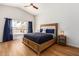Bright bedroom features vaulted ceiling, wood floors, large window, and comfortable furnishings at 1701 E Countrywalk Ln, Chandler, AZ 85225
