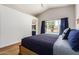 Bright bedroom features vaulted ceiling, wood floors, and large window view of the pool at 1701 E Countrywalk Ln, Chandler, AZ 85225