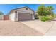 Charming home with a well-manicured front yard, mature landscaping, and a two-car garage at 1701 E Countrywalk Ln, Chandler, AZ 85225