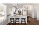 Kitchen features a breakfast bar with seating, stainless appliances, granite countertops, and bright, natural light at 1701 E Countrywalk Ln, Chandler, AZ 85225
