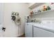 Functional laundry room with modern washer and dryer, ample shelving, and organized storage solutions at 1701 E Countrywalk Ln, Chandler, AZ 85225