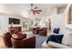 Bright living room with ceiling fan, recessed lights, comfortable seating, and open floor plan at 1701 E Countrywalk Ln, Chandler, AZ 85225