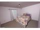 Comfortable bedroom boasts a patterned quilt, natural light, and calm colors, creating a relaxing, inviting atmosphere at 17620 N 17Th Pl # 36, Phoenix, AZ 85022