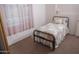 Bright bedroom features a twin bed, soft natural light, and cozy carpet at 17620 N 17Th Pl # 36, Phoenix, AZ 85022