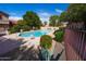 Relaxing community pool area with comfortable seating and beautiful plants on a sunny, bright day at 17620 N 17Th Pl # 36, Phoenix, AZ 85022