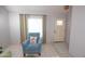 Comfortable living room area with cozy blue chair, footstool, and decorative pillow at 17620 N 17Th Pl # 36, Phoenix, AZ 85022