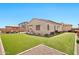 Backyard featuring a well-maintained lawn and a covered patio area at 18394 W Lupine Ave, Goodyear, AZ 85338