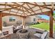 Outdoor patio area featuring comfortable seating around a cozy fire pit at 18394 W Lupine Ave, Goodyear, AZ 85338