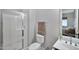 Modern bathroom featuring a glass enclosed shower, toilet and large mirror above the vanity at 18394 W Lupine Ave, Goodyear, AZ 85338