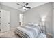 Bright bedroom featuring a ceiling fan, comfortable bed, and ample natural light at 18394 W Lupine Ave, Goodyear, AZ 85338