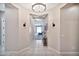 Welcoming entryway with tiled floors and a view of the living room, showcasing a modern aesthetic at 18394 W Lupine Ave, Goodyear, AZ 85338
