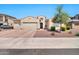 Inviting single-story home featuring a three-car garage and well-maintained desert landscaping at 18394 W Lupine Ave, Goodyear, AZ 85338
