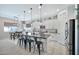 Bright, white kitchen features a large island, stainless appliances, and modern lighting at 18394 W Lupine Ave, Goodyear, AZ 85338