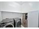 Laundry room equipped with washer, dryer, freezer, and cabinet storage space at 18394 W Lupine Ave, Goodyear, AZ 85338