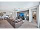 Comfortable living space featuring contemporary décor, a ceiling fan, and a TV at 18394 W Lupine Ave, Goodyear, AZ 85338