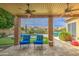Expansive backyard with covered patio, built-in grill, outdoor dining area, swimming pool, and putting green at 1893 W Canary Way, Chandler, AZ 85286