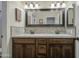 Bathroom with a double sink vanity featuring dark wood cabinetry and neutral-toned countertops at 1893 W Canary Way, Chandler, AZ 85286