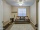 Bedroom featuring a brown leather sofa with decorative pillows, patterned rug, and a ceiling fan at 1893 W Canary Way, Chandler, AZ 85286