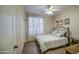 Cozy bedroom with wood-look floors, a ceiling fan, a comfortable bed, and natural light from the window at 1893 W Canary Way, Chandler, AZ 85286