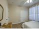Cozy bedroom featuring a ceiling fan, light wood floors, and a closet with white sliding doors at 1893 W Canary Way, Chandler, AZ 85286