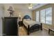 Comfortable bedroom with wood-look floors, a dark wood bed frame, and windows with blinds at 1893 W Canary Way, Chandler, AZ 85286