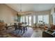 Bright dining room with large windows, wood table, and decorative rug for an inviting space at 1893 W Canary Way, Chandler, AZ 85286