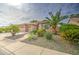 Charming home with well-maintained desert landscaping, gravel, and mature palm trees at 1893 W Canary Way, Chandler, AZ 85286