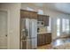 Kitchen featuring stainless steel refrigerator and granite countertops, plus access to a patio at 1893 W Canary Way, Chandler, AZ 85286