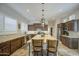 Beautiful kitchen with dark wood cabinets, a center island with barstool seating, and granite countertops at 1893 W Canary Way, Chandler, AZ 85286