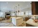 Spacious kitchen with island, granite countertops, stainless steel appliances, and a connected living area at 1893 W Canary Way, Chandler, AZ 85286