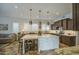 Spacious kitchen featuring a large center island, modern lighting, and stainless steel appliances at 1893 W Canary Way, Chandler, AZ 85286