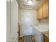 Functional laundry room equipped with a washer, dryer, storage cabinets, and a patterned rug at 1893 W Canary Way, Chandler, AZ 85286