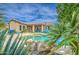 Tranquil backyard oasis with a pristine pool, lush landscaping, and comfortable lounge furniture at 1893 W Canary Way, Chandler, AZ 85286