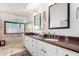 Updated primary bathroom includes a double vanity and a frameless glass shower at 21 W Beryl Ave, Phoenix, AZ 85021