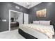Comfortable bedroom with an ensuite bathroom, a large bed, and modern lighting at 21 W Beryl Ave, Phoenix, AZ 85021
