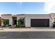 Charming single-story home with desert landscaping and a modern garage door under a blue sky at 21 W Beryl Ave, Phoenix, AZ 85021