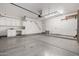 Spacious garage featuring epoxy flooring, built-in cabinets, and ample storage, ideal for vehicles and projects at 21 W Beryl Ave, Phoenix, AZ 85021