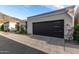Modern two-car garage with a sleek, dark door and contemporary design elements, set in a desert landscape at 21 W Beryl Ave, Phoenix, AZ 85021