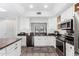 Bright kitchen featuring white cabinets, stainless steel appliances, and granite countertops at 21 W Beryl Ave, Phoenix, AZ 85021