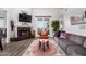 Bright living room with a fireplace, neutral decor, and large windows that let in natural light at 21 W Beryl Ave, Phoenix, AZ 85021