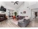Spacious living room with vaulted ceilings, a cozy fireplace, and sliding glass doors for plenty of light at 21 W Beryl Ave, Phoenix, AZ 85021