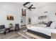 An oversized primary bedroom with tall ceilings, ceiling fan, and ensuite bathroom at 21 W Beryl Ave, Phoenix, AZ 85021