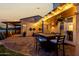 Charming backyard patio featuring a dining set and ambient lighting, perfect for evening gatherings and relaxation at 21 W Beryl Ave, Phoenix, AZ 85021