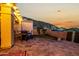 Inviting backyard patio with elegant stone pavers, a dining set, and scenic mountain views at dusk at 21 W Beryl Ave, Phoenix, AZ 85021